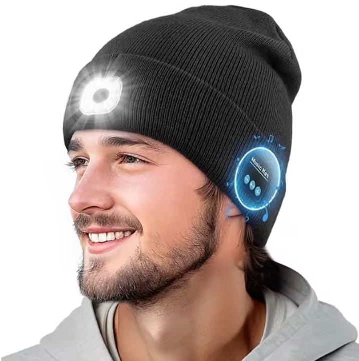 Black beanie with LED light and touch control panel worn by a person on a white background